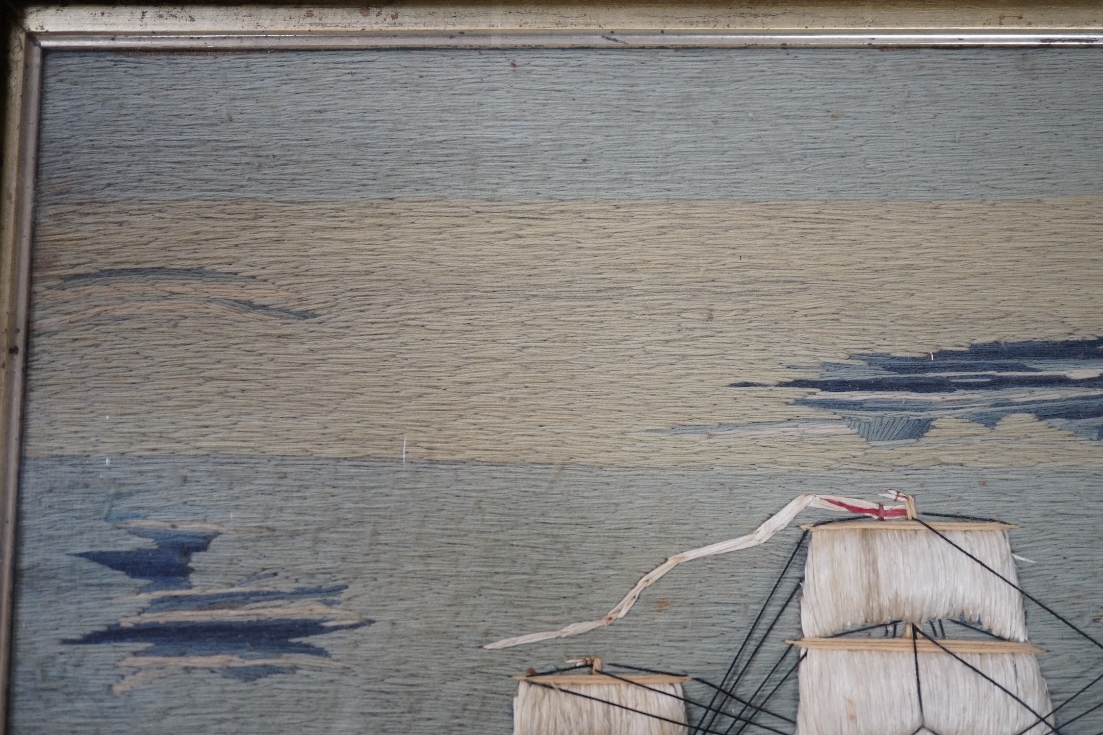 A maple framed 19th century wool work embroidery of a steam ship of the English fleet, 63cms wide, 47cms high